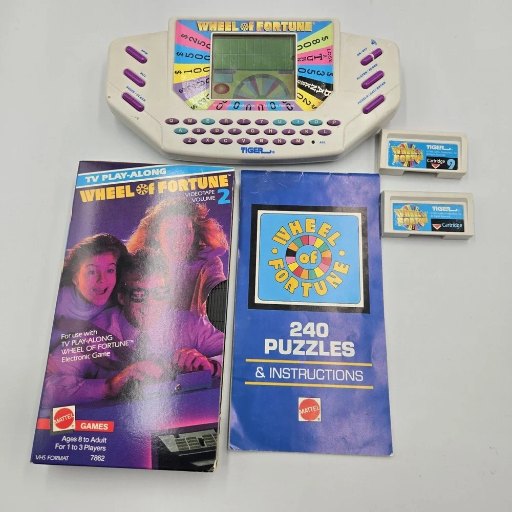 1995 Tiger Hand Held Electronic Wheel Of Fortune Expansion Cartridges Book & VHS